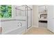 Clean bathroom with a large shower, soaking tub, and updated fixtures at 802 Brookfield Dr, Gibsonville, NC 27249