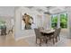 Bright dining room featuring a large wooden table and modern light fixture at 802 Brookfield Dr, Gibsonville, NC 27249