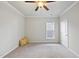 Bright bedroom with carpeted floor, ceiling fan, and neutral wall paint at 821 Blackfriars Loop, Cary, NC 27519
