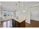 Kitchen island with granite countertop and seating for two at 821 Blackfriars Loop, Cary, NC 27519