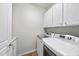 Convenient laundry room with washer, dryer, and cabinets at 821 Blackfriars Loop, Cary, NC 27519