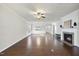 Spacious living room featuring hardwood floors, a fireplace, and a ceiling fan at 821 Blackfriars Loop, Cary, NC 27519