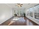 Sunroom with hardwood floors, a ceiling fan and access to deck at 821 Blackfriars Loop, Cary, NC 27519
