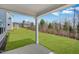 Beautiful backyard and covered patio with lush green lawn and forest backdrop at 1029 Dillon Lake Dr, Knightdale, NC 27545