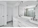 Bathroom features a double sink vanity, a large mirror, modern fixtures, and a glass door shower at 1029 Dillon Lake Dr, Knightdale, NC 27545