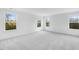 Bright bedroom with neutral carpeting and multiple large windows that let in a lot of natural light at 1029 Dillon Lake Dr, Knightdale, NC 27545