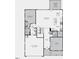 Floorplan of lower level with bedrooms, kitchen, dining, garage, and patio at 1029 Dillon Lake Dr, Knightdale, NC 27545