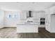 Bright, modern kitchen features white cabinets, stainless steel appliances, island, and updated countertops at 1029 Dillon Lake Dr, Knightdale, NC 27545