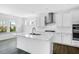 Bright, modern kitchen features white cabinets, stainless steel appliances, island, and updated countertops at 1029 Dillon Lake Dr, Knightdale, NC 27545