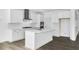 Bright, modern kitchen features white cabinets, stainless steel appliances, island, and updated countertops at 1029 Dillon Lake Dr, Knightdale, NC 27545