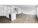 Open-concept living space features the kitchen, modern flooring, staircase, and plenty of natural light at 1029 Dillon Lake Dr, Knightdale, NC 27545