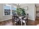 Charming dining room with a dark wood table and four chairs near large windows at 1040 Myers Point Dr, Morrisville, NC 27560