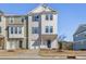 Two-story townhome with white and green siding, two-car garage, and a landscaped yard at 1040 Myers Point Dr, Morrisville, NC 27560