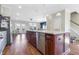 Open concept kitchen with large island, stainless steel appliances, and hardwood floors at 1040 Myers Point Dr, Morrisville, NC 27560