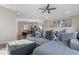 Spacious living room featuring a comfy sectional sofa and ottoman, with an open concept view of the kitchen at 1040 Myers Point Dr, Morrisville, NC 27560