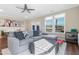 Relaxing living room with sectional sofa, ottoman, and access to a deck at 1040 Myers Point Dr, Morrisville, NC 27560
