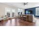 Bright living room with hardwood floors, sectional sofa, and access to a deck at 1040 Myers Point Dr, Morrisville, NC 27560