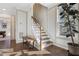 Elegant staircase with wooden railings and a built-in bench, leading to the upper level at 1040 Myers Point Dr, Morrisville, NC 27560