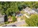 Aerial view of a charming blue house with a fenced yard, located in a tree-lined neighborhood at 105 Cooke St, Raleigh, NC 27601