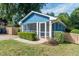 Blue house with a screened porch, landscaped yard, and a wooden fence at 105 Cooke St, Raleigh, NC 27601