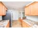 Open concept kitchen with stainless steel refrigerator and ample counter space at 105 Cooke St, Raleigh, NC 27601