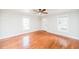 Living room with hardwood floors, large windows, and a ceiling fan at 105 Cooke St, Raleigh, NC 27601