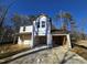 Two-story house under construction with a two-car garage and vinyl siding at 105 Forest Dr, Graham, NC 27253