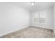 Spacious bedroom with neutral carpeting and large window at 1099 Talisker Way, Burlington, NC 27215