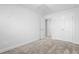 Well-lit bedroom with carpet, double doors, and access to hallway at 1099 Talisker Way, Burlington, NC 27215
