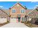Two-story townhome with brick and stone exterior, two-car garage, and curb appeal at 1099 Talisker Way, Burlington, NC 27215