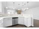 Contemporary kitchen with white cabinets, quartz countertops, and stainless steel appliances at 1099 Talisker Way, Burlington, NC 27215