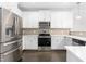Stainless steel appliances and white cabinetry in this modern kitchen at 1099 Talisker Way, Burlington, NC 27215