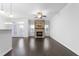Open living room with hardwood floors, stone fireplace, and access to backyard at 1099 Talisker Way, Burlington, NC 27215