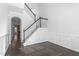 Elegant staircase with dark wood railing and white risers, leading to upper level at 1099 Talisker Way, Burlington, NC 27215