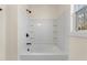 Bathroom with shower tub combo, tile surround, and built-in shelves at 1523 Alta Vista Ln, Graham, NC 27253