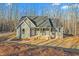 Gray house with front porch and steps, surrounded by woods at 1523 Alta Vista Ln, Graham, NC 27253