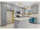 Gray kitchen with island, stainless steel appliances, and wood floors at 1523 Alta Vista Ln, Graham, NC 27253