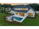 Aerial view of backyard with a modern pool, outdoor patio, and lush landscaping offering a private retreat at 1608 Legacy Ridge Ln, Wake Forest, NC 27587