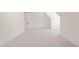 Finished attic space with white walls, neutral carpet, a standard door, and modern base trim at 1608 Legacy Ridge Ln, Wake Forest, NC 27587