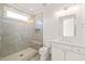Modern bathroom featuring a glass shower, white vanity, and neutral colored floor tiles at 1608 Legacy Ridge Ln, Wake Forest, NC 27587