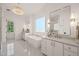 Bright bathroom with a standalone tub, double vanities, a large mirror, and elegant lighting at 1608 Legacy Ridge Ln, Wake Forest, NC 27587