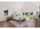 Spacious bedroom featuring large windows offering stunning views of the lush backyard and vaulted ceilings at 1608 Legacy Ridge Ln, Wake Forest, NC 27587