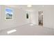 Bright bedroom featuring neutral carpet, white walls, and an ensuite bathroom at 1608 Legacy Ridge Ln, Wake Forest, NC 27587