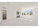 Bright bonus room with neutral carpet, large windows, and a wet bar at 1608 Legacy Ridge Ln, Wake Forest, NC 27587