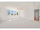 Bright bonus room featuring a large window with neighborhood views and neutral carpet at 1608 Legacy Ridge Ln, Wake Forest, NC 27587