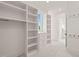 Spacious walk-in closet with custom shelving, drawers, and ample storage space at 1608 Legacy Ridge Ln, Wake Forest, NC 27587