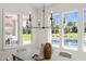 Bright dining area with decorative chandelier offers large windows overlooking the pool and backyard at 1608 Legacy Ridge Ln, Wake Forest, NC 27587