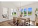 Bright dining room with a view of the expansive backyard, featuring a modern table, stylish chairs, and natural light at 1608 Legacy Ridge Ln, Wake Forest, NC 27587