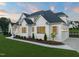 Beautiful two-story white house with well-manicured lawn and landscaping at 1608 Legacy Ridge Ln, Wake Forest, NC 27587