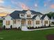 A beautiful two-story home with white siding, dark roof, manicured lawn, and inviting front entrance at 1608 Legacy Ridge Ln, Wake Forest, NC 27587